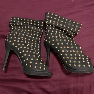 Spiked open toe heeled bootie.